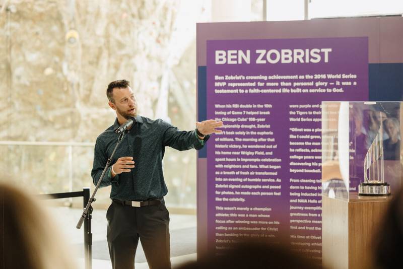 Ben Zobrist, an Olivet Nazarene University alumnus and Chicago Cubs 2016 World Series MVP, speaks to students on Sept. 3, 2025. Zobrist is loaning the World Series MVP trophy, at right, to the University to be a permanent fixture inside Olivet’s Perry Recreational Center.