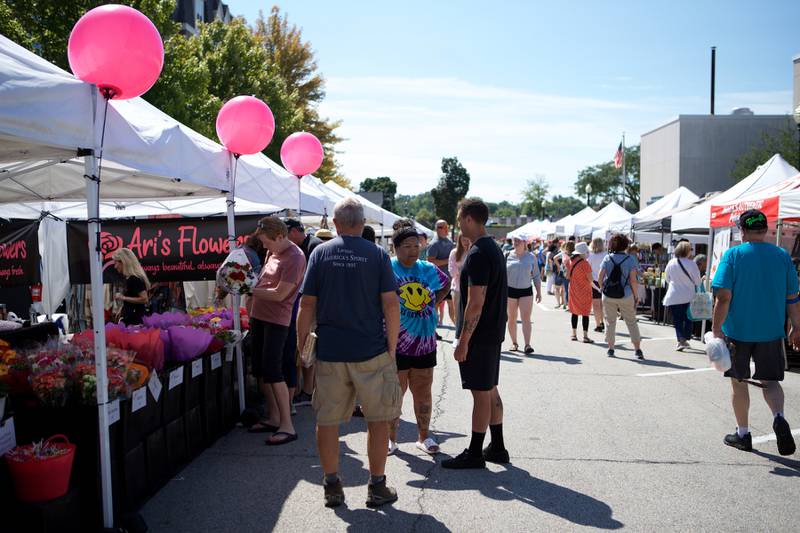 Market goers visit the Wheaton French Market on Saturday Sept. 3, 2022 in Wheaton.