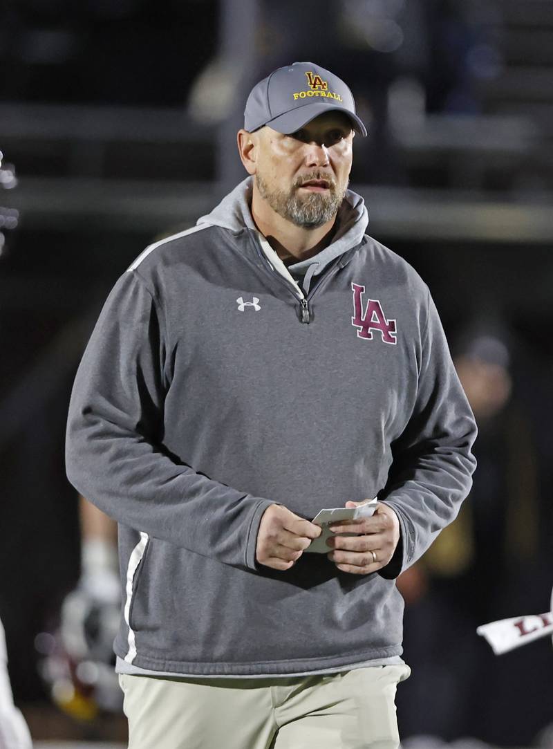 Loyola head coach Beau Desherow watches warmups before the varsity football game between Loyola Academy and Mt. Carmel high school on Friday, Oct. 25, 2024 in Chicago.