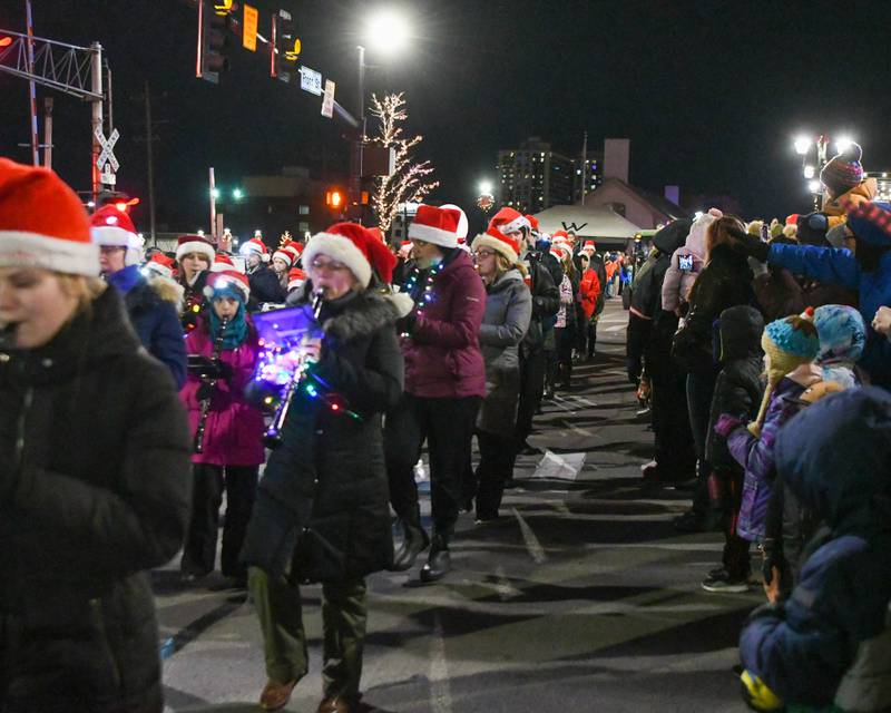 The West Suburban Home School Band performs during the holiday Parade in downtown Wheaton on Friday Nov. 24, 2023.