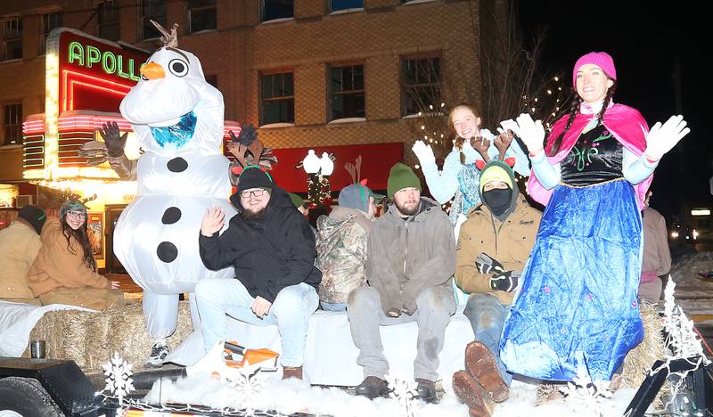 People ride the "Frozen" float during the "Night of Lights" parade on Friday, Dec. 5, 2025 downtown Princeton. The event featured the Christmas tree lighting at Veterans Park a lighted Christmas parade down Main Street,  Living Windows, a Candy Cane Hunt, and visits with Santa.