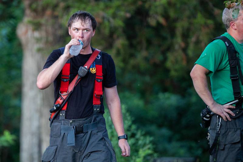 Firefighter drinks water on scene on Saturday, July 19, 2025 at 2896 E 1380th Rd in Utica.