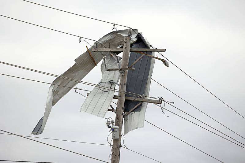Derbis is seen tangled in power lines outside of Amboy Saturday, April 1, 2023 the day after a line of powerful storms roared through the Sauk Valley.