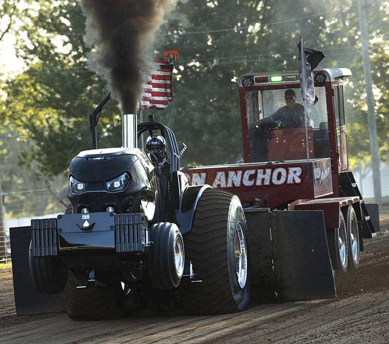 Adam Stevens of Shannon lifts the tires on his Case IH as he works down the track Wednesday, Aug. 7, 2024 at the Carroll County Fair.