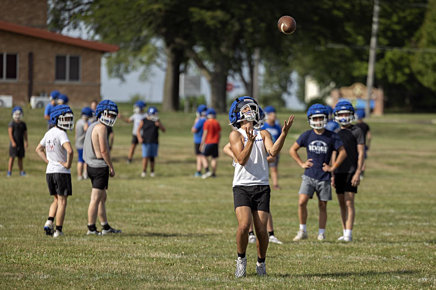 Newman players run through drills during first day of football practice Monday, August 7, 2023.