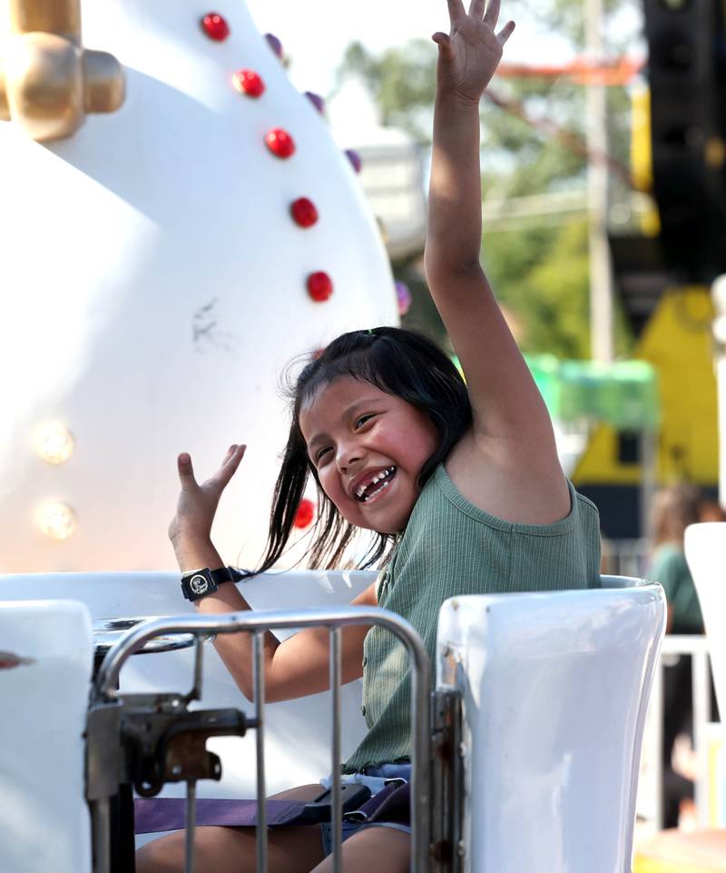 Emily Martinez, 6, from DeKalb, rides the tea cups at the carnival Friday, Aug. 23, 2024, during the DeKalb Corn Fest.