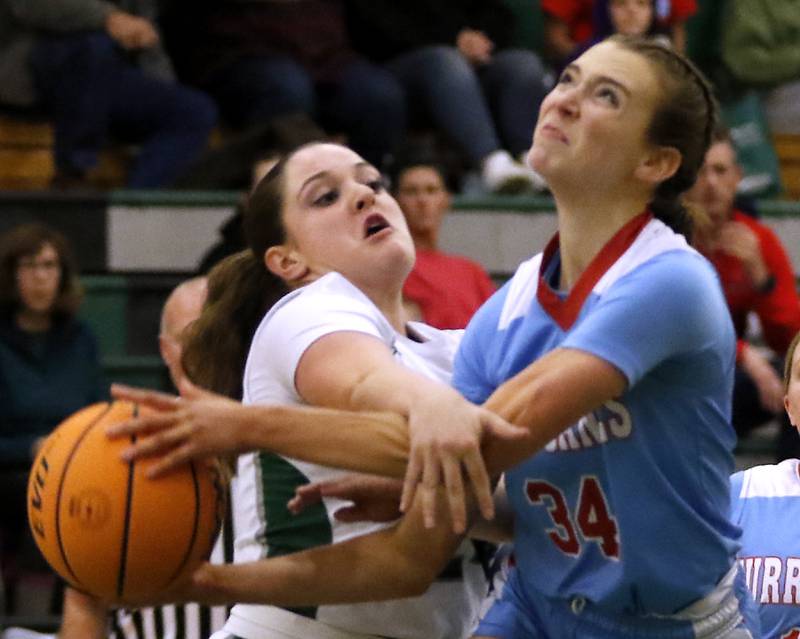 Grayslake Central's Annie Wolff fouls Marian Central's Juliette Huff as she drives to the basket during a nonconference girls basketball on Monday, Jan. 13, 2025, at Grayslake Central High School.