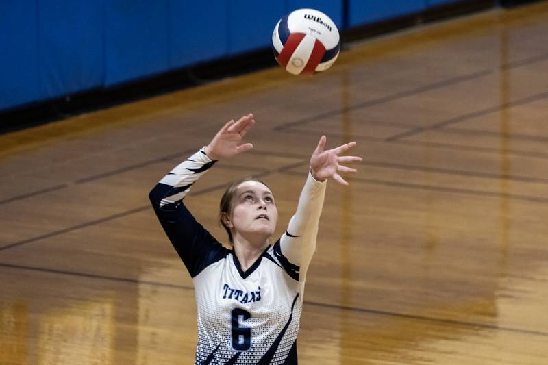 Illinois Mathematics & Science Academy's Kendall Adkins serves during a varsity volleyball game against Joliet Central at Joliet Central on Oct. 20, 2025.