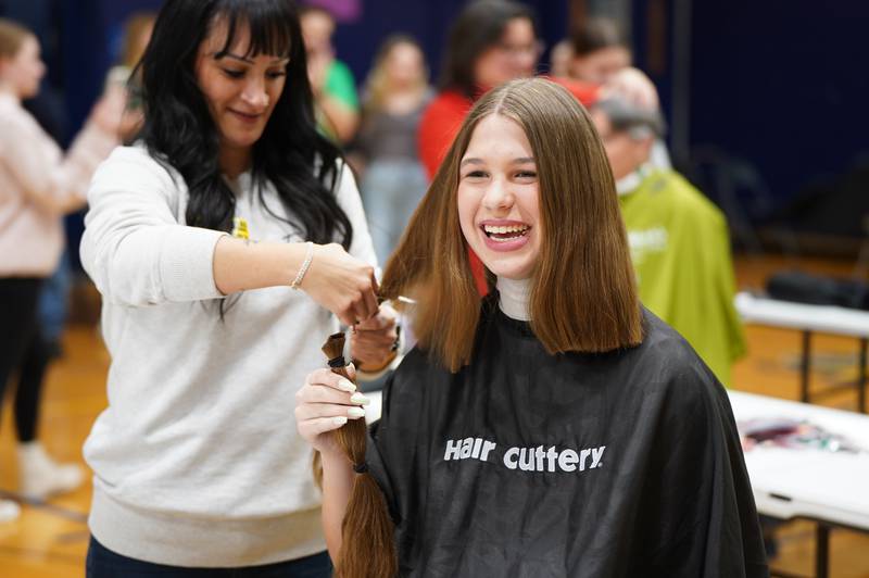 Crystal Lake Bernotas Middle School eight-grade student Brianna Buelow donates 14 inches of hair and raises over $5,000 for childhood cancer research.