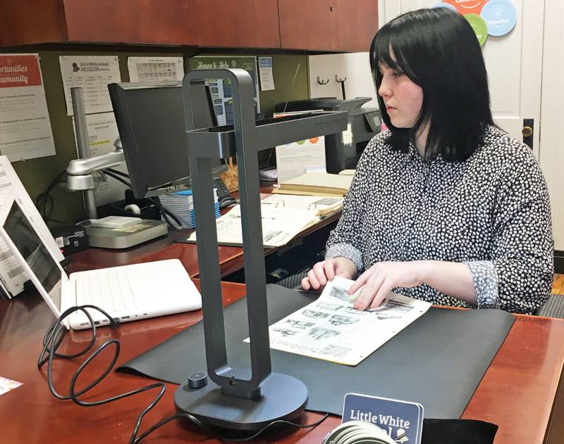 Museum assistant Emily Dutton uses the Little White School Museum’s new Czur Aura document scanner to digitize a series of historic documents in the museum’s collections. The scanner was purchased with a $500 Covid grant issued last year by the Village of Oswego. The scanner is being used to digitize historic documents in the museum’s collections to preserve them and to make them more accessible for researchers.