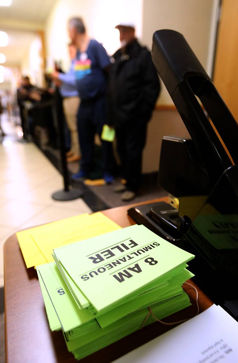 A stack of “8 AM” cards rests on a desk of the McHenry County Clerk's Office in Woodstock on Monday, Oct. 27, 2025, the first day to file paperwork to run in the 2026 primary election. Those in line at 8 a.m. get to be first on the ballot, or in a drawing for first place if more than one candidate makes the deadline.