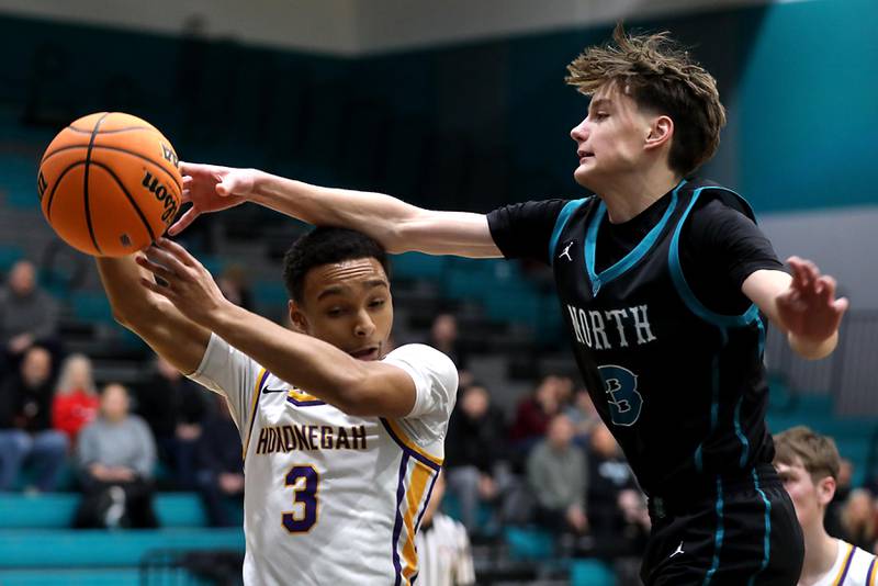 Woodstock North's Luke Bigler (right) tries to knock the basketball away from Hononegah's Caleb Hart as the battle for a rebound during the 2025 Hoops for Healing tournament basketball game on Wednesday, Nov. 26, 2025, at Woodstock North High School.