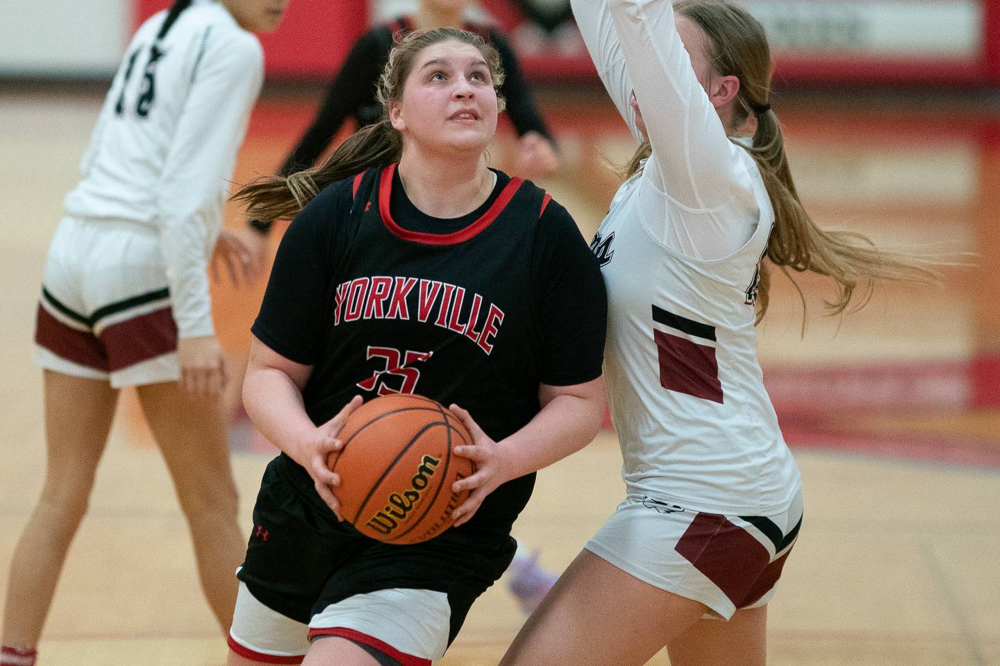 Yorkville's Madison Spychalski (35) posts up against Plainfield North's Isabella Gruber (23) during a Yorkville girls 4A regional semifinal basketball game at Yorkville High School on Tuesday, Feb 14, 2023.