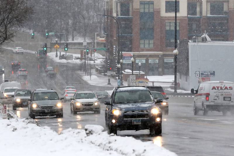 Cars navigate the snowfall on East Algonquin Road on Thursday, Feb. 4, 2021 in Algonquin.