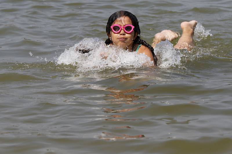 A girls swims at Crystal Lake's Main Beach on Friday, June 21, 2024.