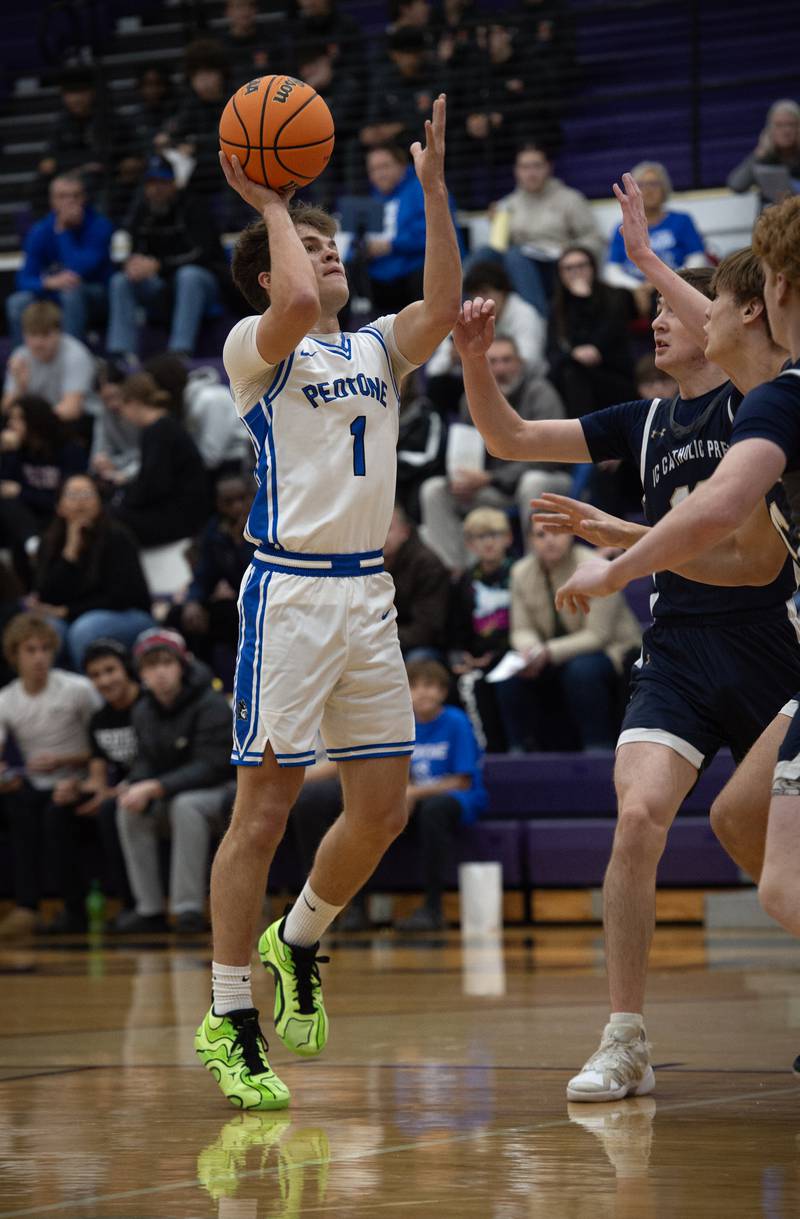 Peotone's Alex Chenoweth, left, elevates for a shot against IC Catholic in the Thanksgiving tournament at Manteno High School on Monday, November 24, 2025.