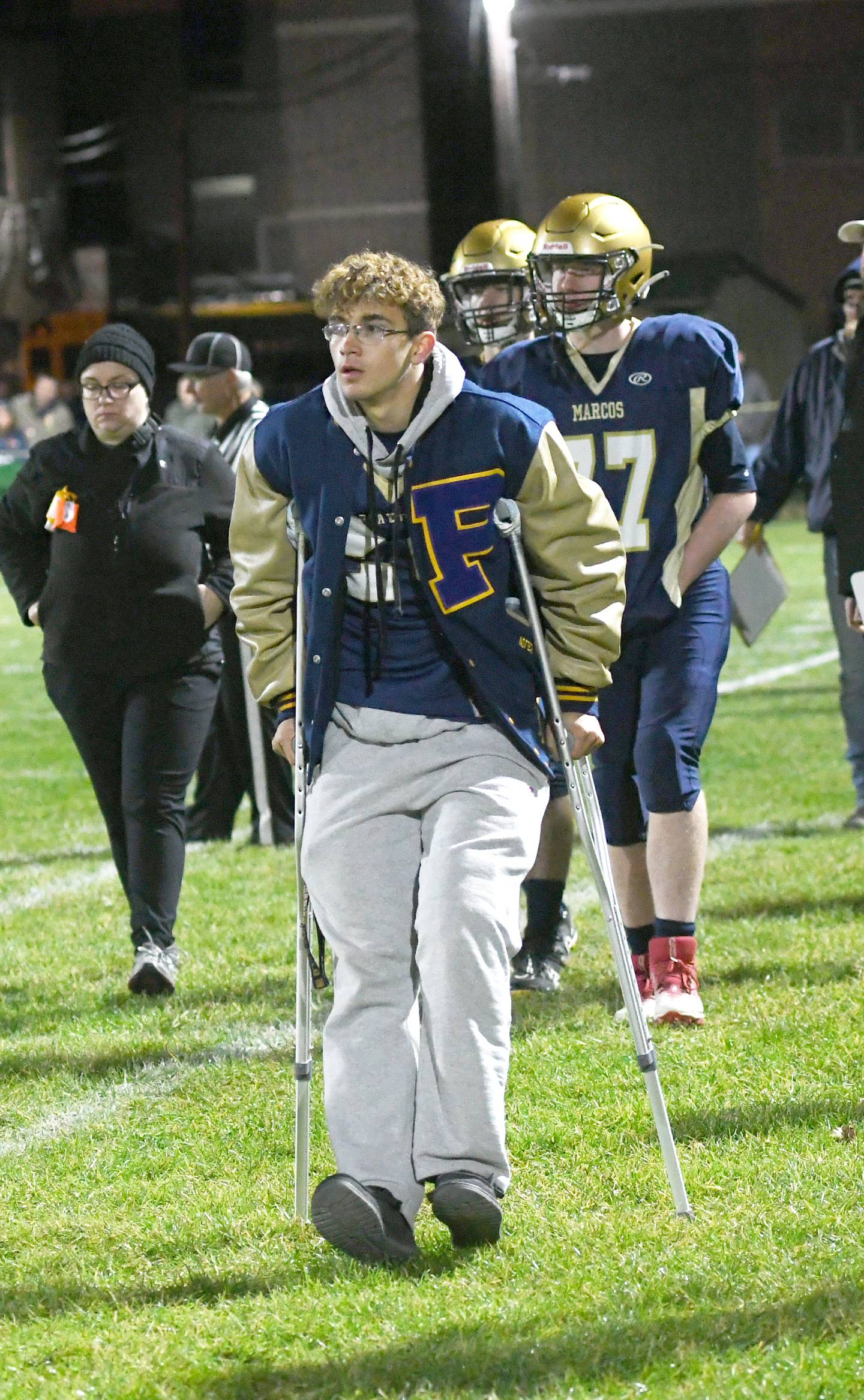 Polo's Avery Grenoble walks the Marcos' sideline on crutches during the first round 8-man playoff action against Kirkland Hiawatha on Friday, Oct. 28. Grenoble was injured during practice one day before the first round playoff game.