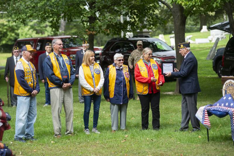 Morrison American legion commander Larry Zuidema presents a certificate of appreciation to the Morrison Lions Club for a drive that replaced 350 flags along routes 30 and 78. The recognition came during a flag retirement ceremony Sunday, Sept. 25, 2022 in Morrison.