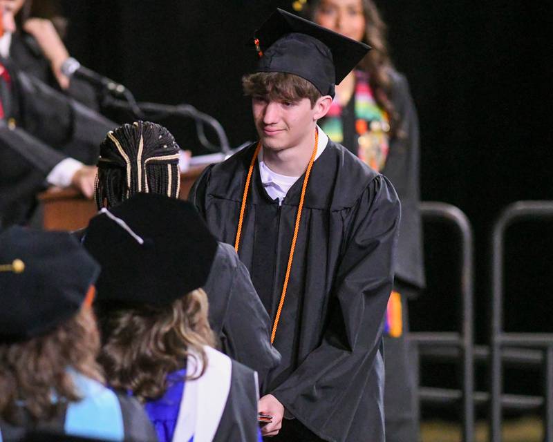 DeKalb High School senior Levi Anderson is all smiles as he receives his diploma on Saturday, May 24, 2025, during the Class of 2025 Commencement ceremony held at the NIU Convocation Center in DeKalb.