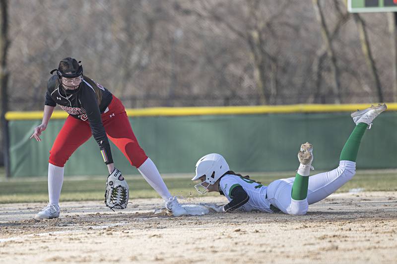 Rock Falls’ Madison Morgan slides in safely at third base as Forreston’s Kylie Dieterman looks to make the tag Thursday, March 28, 2024 at Rock Falls High School.