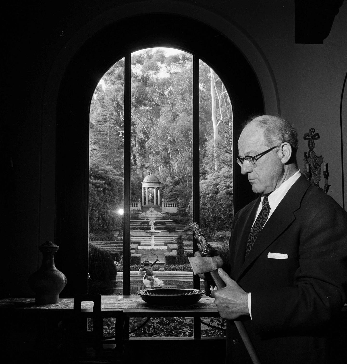 Avery Brundage, head of the International Olympic Committee, holds an antique sword from Bali, Indonesia, at his home in Santa Barbara, Calif., April 11, 1956. The sword is from Brundage's large and valuable collection of Asian Art. It was one of his few major interests outside the field of amateur athletics. For years Brundage was known as the "ruler" of amateur sport. He headed the U.S. Olympic Association for 24 years and served seven terms as president of the American Athletic Union. His staunch advocacy  of purity in amateur sports made him the center of many attacks and controversies.