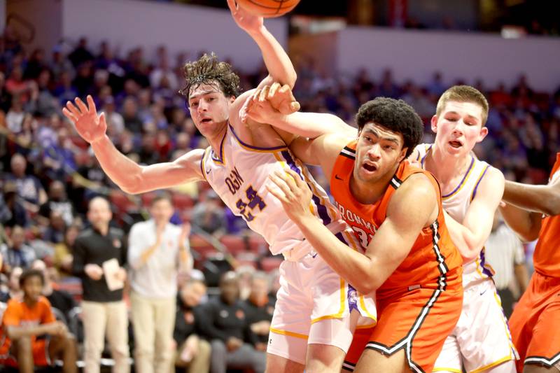 Downers Grove North’s Aidan Akkawi (left) and Normal Community’s Jaheem Webber go after a rebound during the Class 4A Normal Supersectional game on Monday, March 4, 2024.