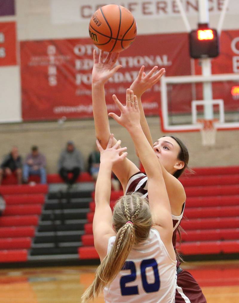 Morris's Lily Hansen looks to shoot a jump shot over Princeton's Reese Reviglio during the Lady Pirate Holiday Tournament on Wednesday, Dec. 20, 2023 in Kingman Gym.