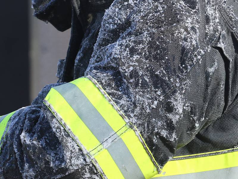 Ice sticks to a firefighter while fighting a fully engulfed house fire in the 800 block of Bucklin Street on Friday, Jan. 23, 2026 in La Salle.