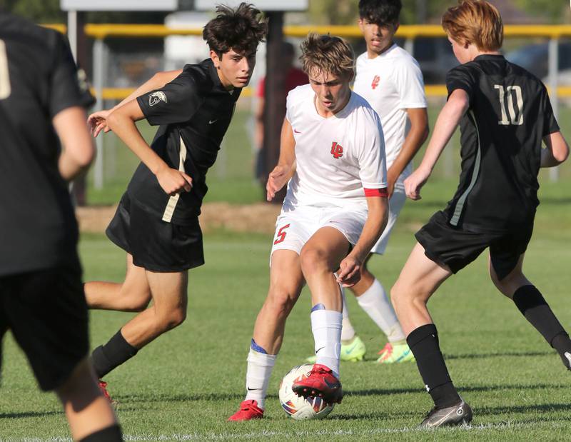 La Salle-Peru's Seth Adams splits two Sycamore defenders during their game Wednesday, Sept. 7, 2022, at Sycamore High School.