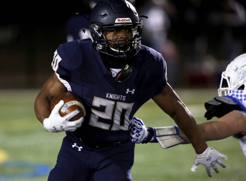 IC Catholic Prep’s Kyle Franklin runs the ball during their football game at Plunkett Park in Elmhurst, Ill., on Friday, March 19, 2021.
