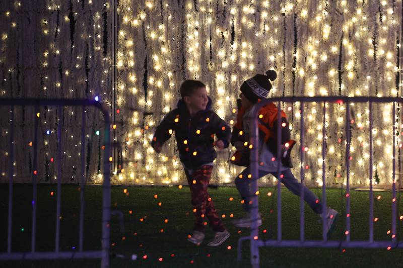 Kids play along the lights at the GLOW Holiday Festival at Slammers Stadium on Wednesday, Nov. 27, 2024 in Joliet.