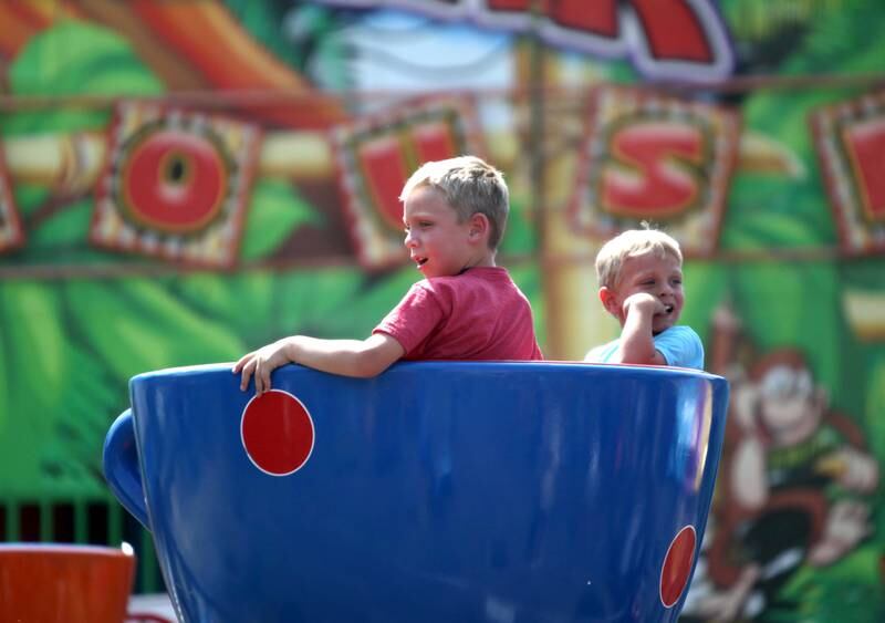Brothers Beckett, 7, and Brooks Krantz, 4, ride the teacups during the first day of the 2023 Swedish Days Festival in Geneva on Wednesday, June 21, 2023.