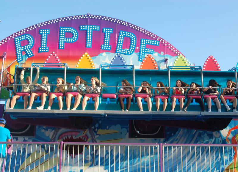 Teens laugh as they ride Riptide in the opening hours of Park Fest on Friday, May 26, 2023, in downtown Streator.