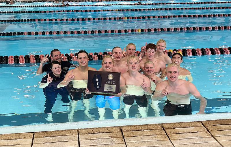 Sterling swimmers and coaches Kyle Ruiz (left rear) and Jamie Ruiz (left front) all jumped in the pool – with the sectional championship plaque in tow – after winning the team title at the United Township Sectional on Saturday in East Moline.