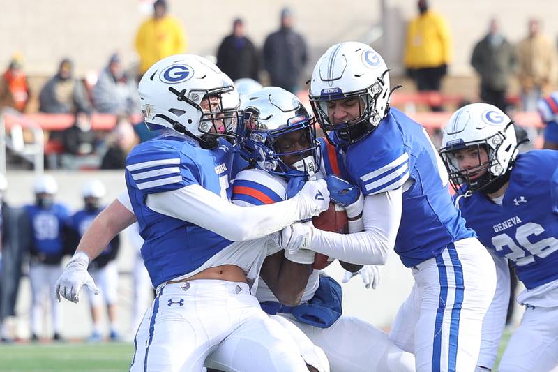 Geneva’s Dylan Reyes, left, and Nelson Wendell tackles  East St. Louis’ Ronnie GoMiller in the Class 6A state championship on Saturday, Nov. 30, 2024 in Normal.