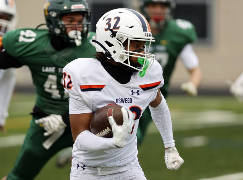Oswego's Andrew Shaw (32) runs with the ball during the varsity football second-round 8A playoff game between Oswego and Lane Tech on Saturday, Nov. 8, 2025 in Chicago.