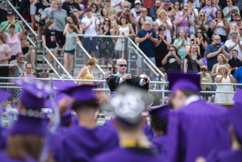 Dixon High School Principal Michael Grady, who is retiring after 18 years, is given a standing ovation after completing his final graduation speech Sunday.