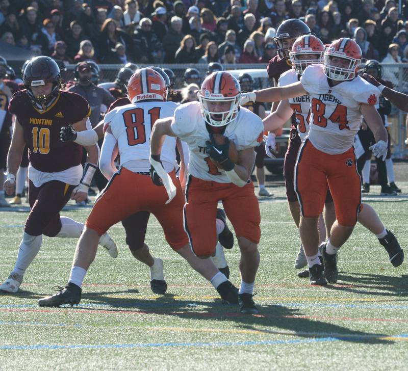 Byron's Brayden Knoll (1) breaks through the line and heads to the end zone during 3A semifinal action against Lombard-Montini in Lombard on Saturday, Nov. 18, 2023.