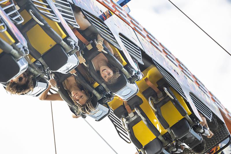 Riders go upside down on the Fireball Wednesday, July 3, 2024 on the opening day of the Petunia Fest carnival. The carnival will open Thursday at 1 and run until 11.