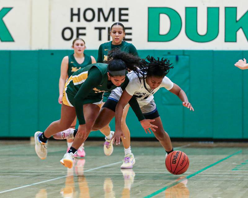 Oswego East's Desiree Merritt (21) battles Waubonsie Valley's Arianna Garcia (1) for possession at the York Thanksgiving Tournament. Nov 13, 2023.