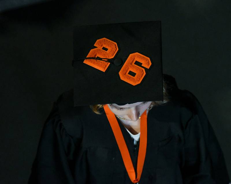 A St. Charles East graduate walks out of the graduation ceremony displaying the numbers 26 on Monday, May 18, 2026, at the Convocation Center in DeKalb.