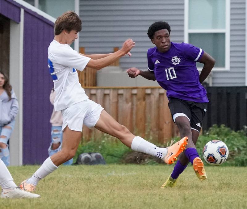 Plano's Davione Stamps (10) shoots the ball against Woodstock's Dominic Vogel (22) during a soccer match at Plano High School on Monday, Sept. 11, 2023.
