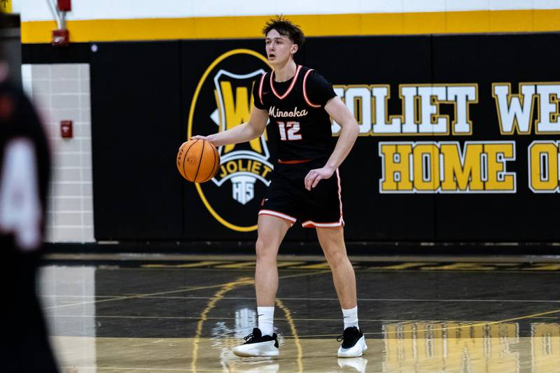 Minooka's Kyle Rodak scans the court during a varsity boys basketball game against Joliet West at Joliet West on Jan. 6, 2026.