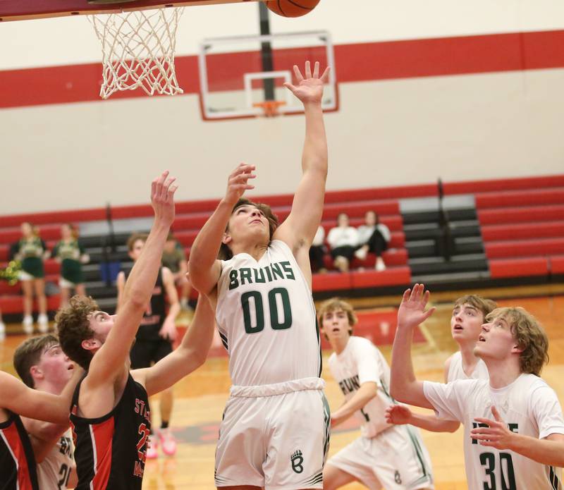 St. Bede's Nathan Husser grabs a rebound over Stillman Valley's Ethan Szarkowicz defends during the 49th annual Colmone Class on Thursday, Dec. 7, 2023 at Hall High School.