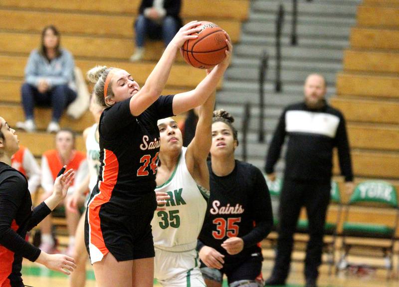 St. Charles East’s Marissa Kalamaris (24) gets a rebound over York’s Angelina Downer during a game in the 11th Annual Thanksgiving Tournament in Elmhurst on Monday, Nov. 14, 2022.