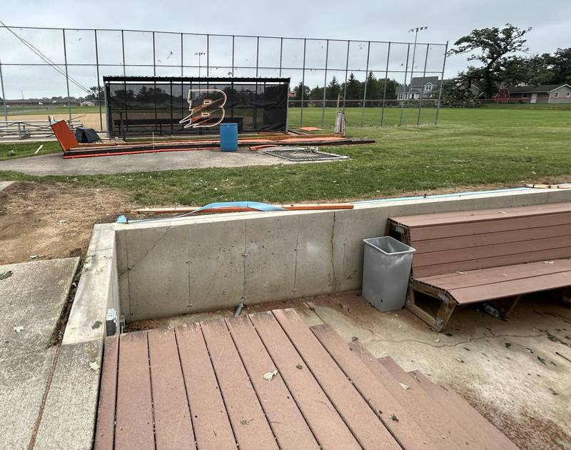 This dugout on the Byron High School's softball field was torn from its base and tossed against another field's fence during Monday's storm. Crews were busy on Tuesday, July 16, 2024 clearing the debris and surveying the damage.