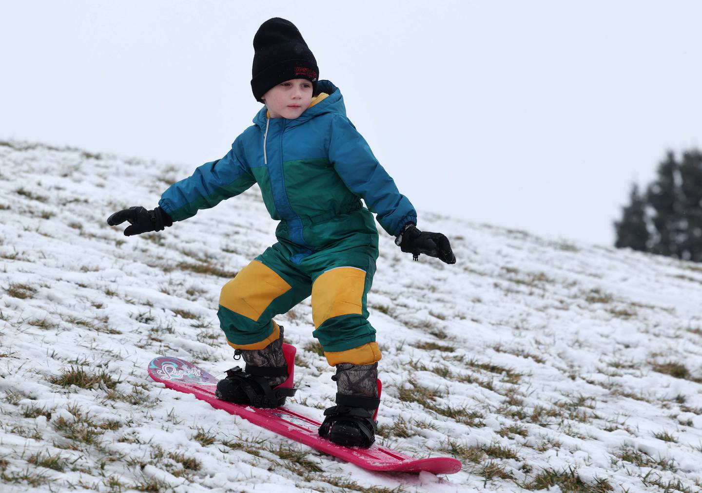 Alonzo Galvin, 5, from Cortland, takes advantage of the snowfall as he snowboards down the Northwestern Medicine Sled Hill Saturday, Jan. 6, 2023, near the Sycamore Park District Community Center.