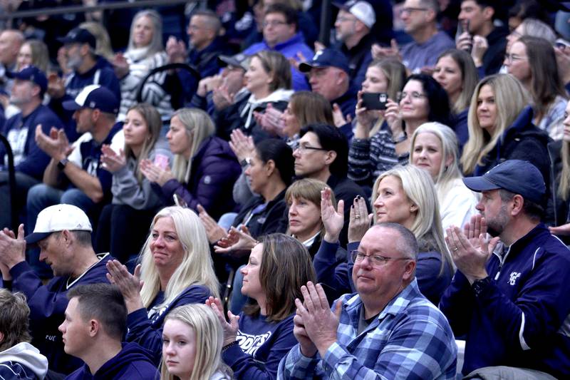 Community members acknowledge the Trojan players, coaches, and staff during a celebration of the IHSA Class 6A Champion Cary-Grove football team at the high school Sunday.