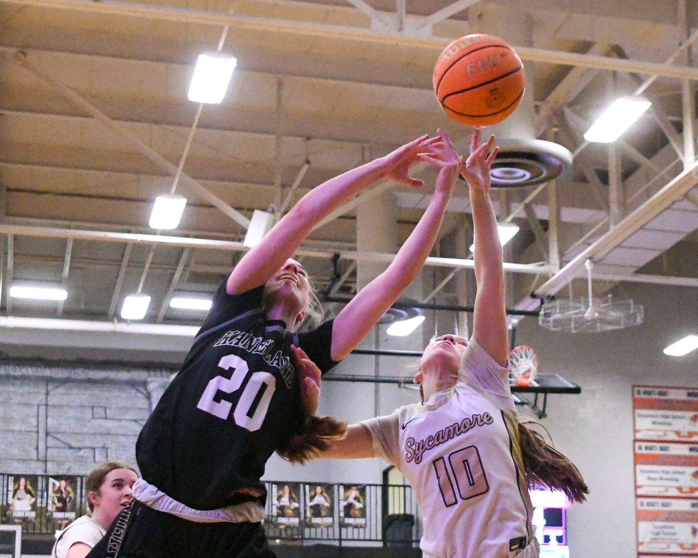 Kaneland's Samantha Kerry (20) and Sycamore's Cortni Kruizenga (10) battle for a loose ball during the game on Monday Feb. 10, 2025, held at Sycamore High School.
