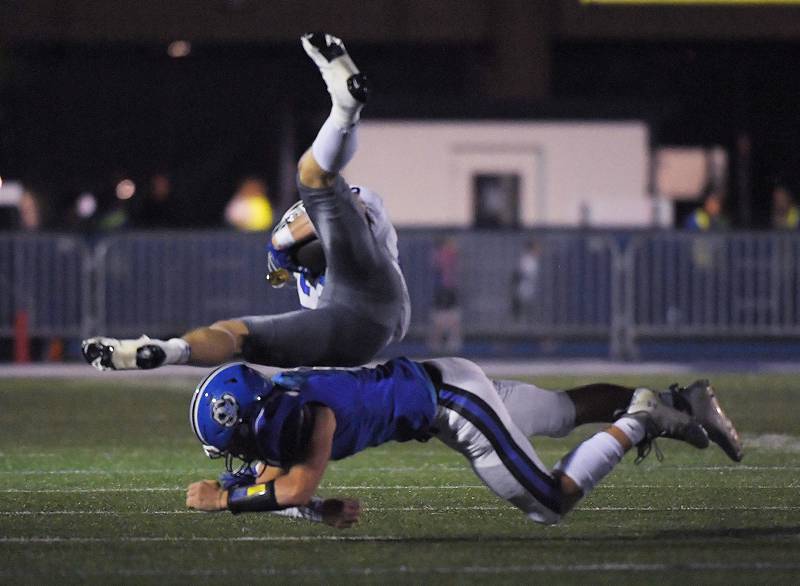 Lake Zurich’s Coplan Oettinger tackles Warren’s Liam Wiley in a football game in Lake Zurich on Friday, September 22, 2023.